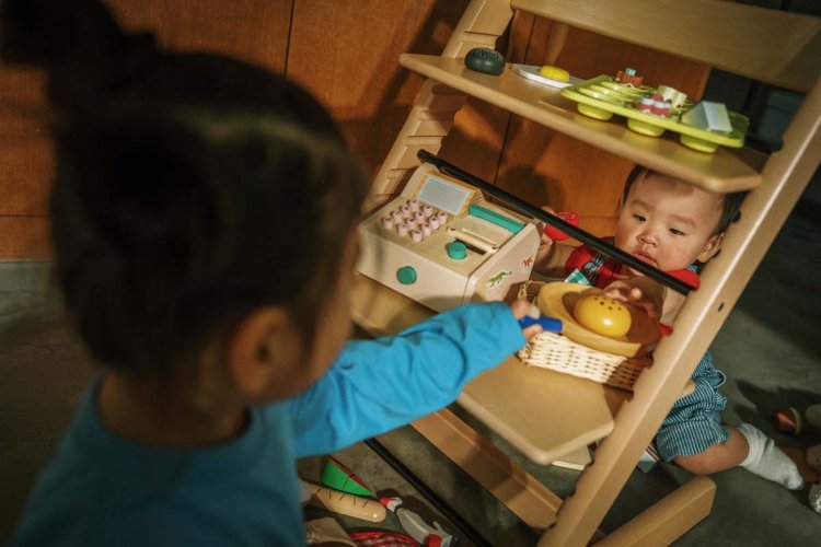 Kinder spielen Verkaufsladen auf Stuhl