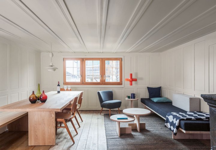 Getäftertes Wohnzimmer mit Esstisch und Sofaecke