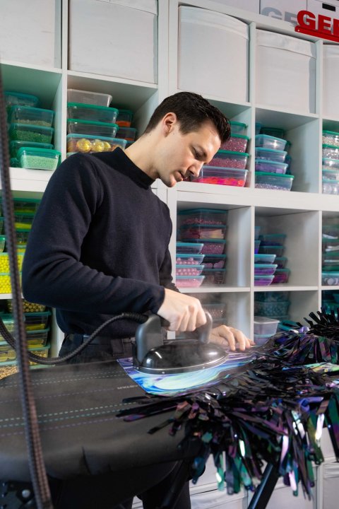 Der Modedesigner Kévin Germanier bügelt eines seiner Kleider mit dem in Kooperation mit Laurastar entworfenen Bügeleisen in seinem Atelier.