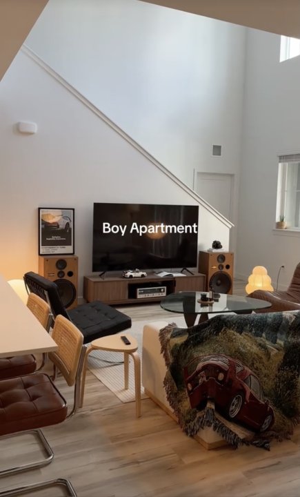 Ein Screenshot aus dem TikTok-Video von Garrett Cottles Apartment-Tour das sein Wohnzimmer mit diversen Mid-Century-Möbeln zeigt.